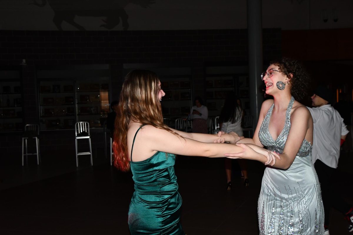 Alexis Peters (11) and Isa Saddler (11) swing dance during the annual winter homecoming dance on Feb. 14. The dance was produced by Student Council. 
