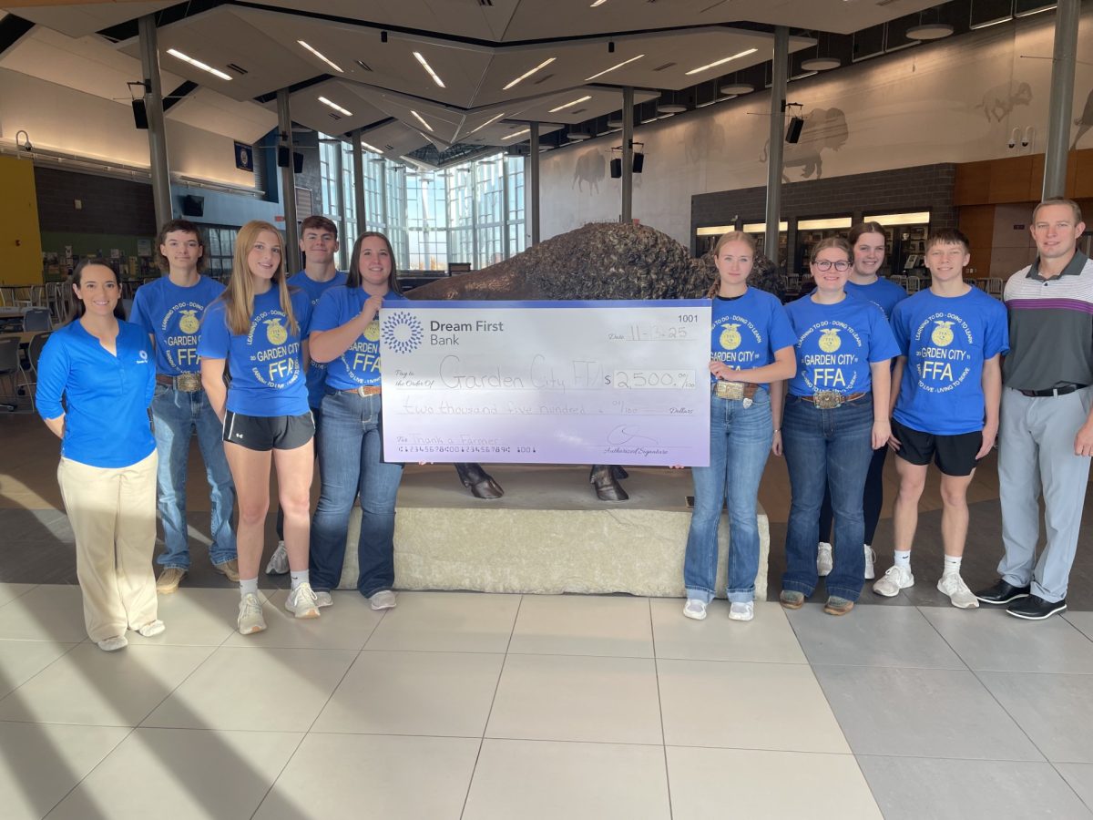 Cort Baker (10), Clara Ford (10), Andrew Wessels (10), Jozlynn Main (12), Taylor Hoke (11), Andi Heckel (11), Macy Hands (10) and Kennan Murrell (10) stand with representatives from Dream First Bank. They received a check for the FFA program.