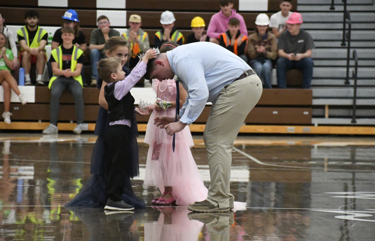 The Potts children crown Zachary Kitch (12) Winter homecoming king during the homecoming ceremony on Feb 14.
