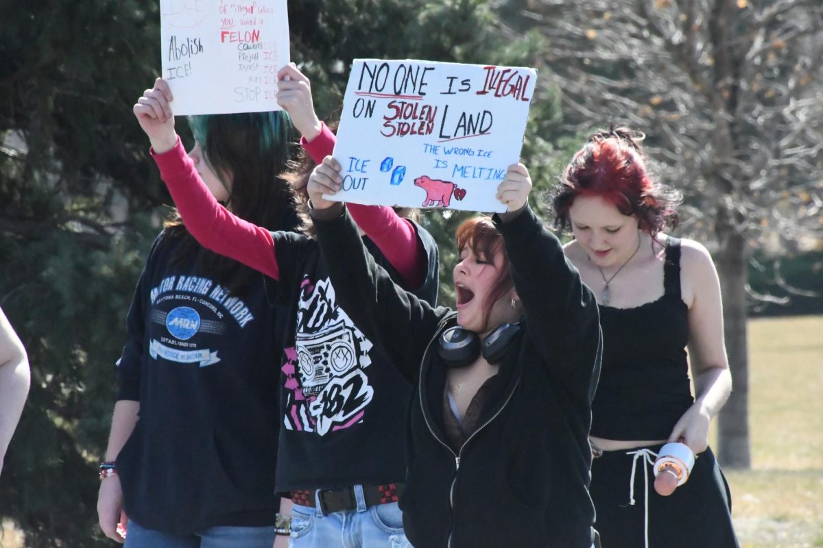 Emmerett White (11), Gwen Bergstrom (9), Sophia Henry (9) and Alyssa Rupp (9) protest at Dean Wiley Park on March 6. They could be seen holding signs and microphones, voicing anti-ICE chants.